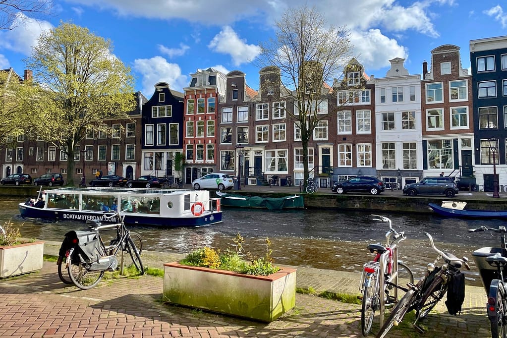 About Simply Living Happy About Boat goind down the canal Amsterdam